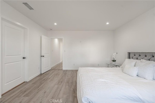 bedroom with recessed lighting, light wood-style floors, visible vents, and baseboards