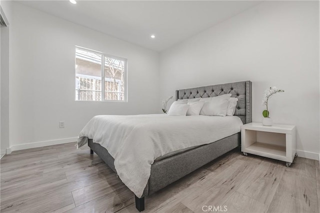 bedroom featuring recessed lighting, light wood-type flooring, and baseboards