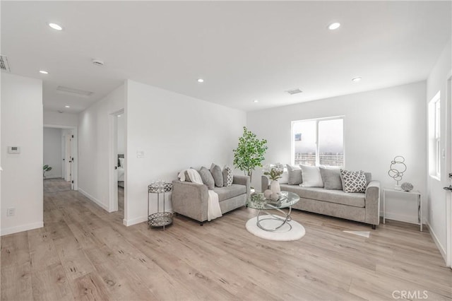 living area featuring recessed lighting and light wood-style flooring