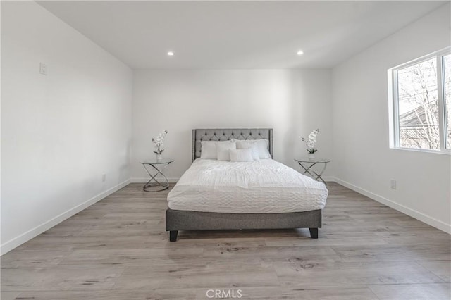 bedroom featuring recessed lighting, baseboards, and light wood-style floors