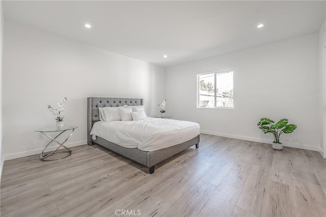 bedroom with recessed lighting, baseboards, and light wood finished floors