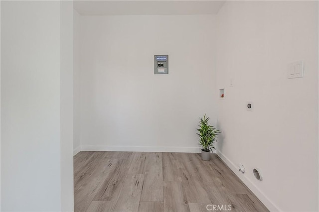 clothes washing area with electric dryer hookup, washer hookup, hookup for a gas dryer, light wood finished floors, and baseboards