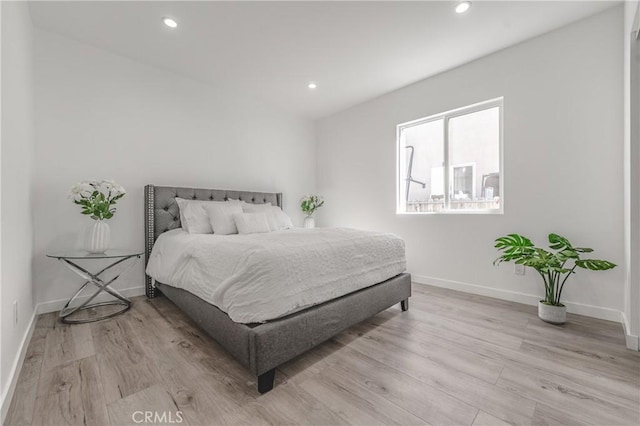 bedroom featuring recessed lighting, baseboards, and light wood finished floors