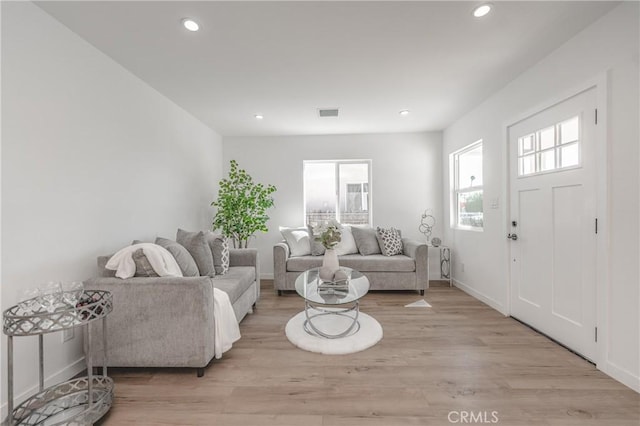 living room featuring visible vents, recessed lighting, and light wood-type flooring