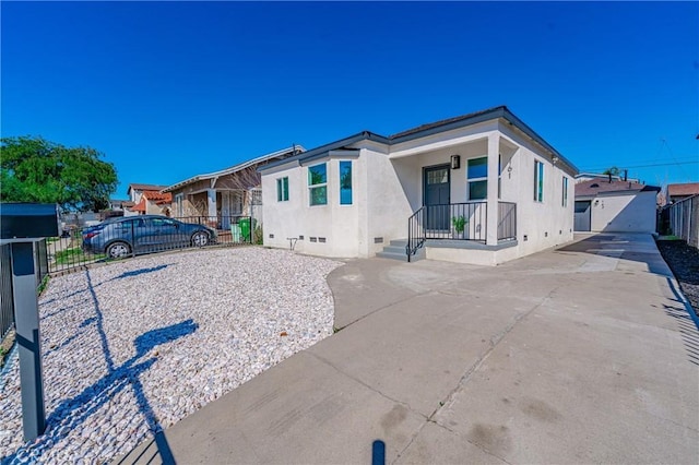 view of front of home featuring crawl space, stucco siding, and fence