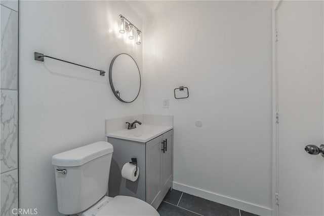 bathroom featuring tile patterned floors, baseboards, toilet, and vanity