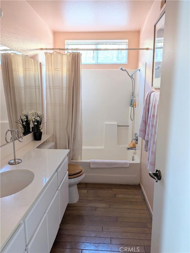 full bathroom with toilet, vanity, shower / bath combo, and wood-type flooring