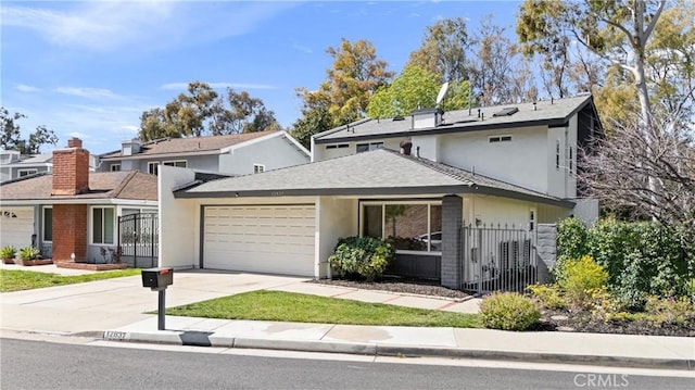 traditional home featuring stucco siding, a garage, roof with shingles, and driveway