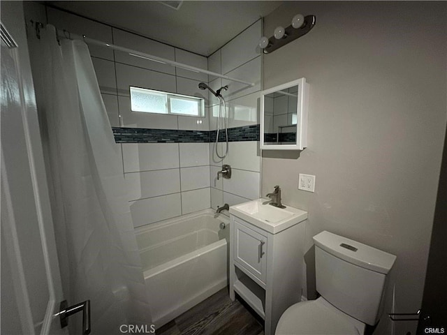 bathroom with vanity, toilet, wood finished floors, and shower / tub combo with curtain