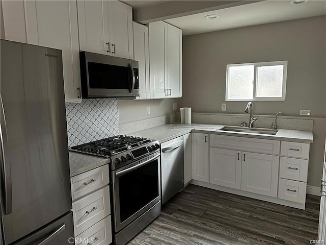 kitchen featuring a sink, white cabinetry, appliances with stainless steel finishes, and light countertops