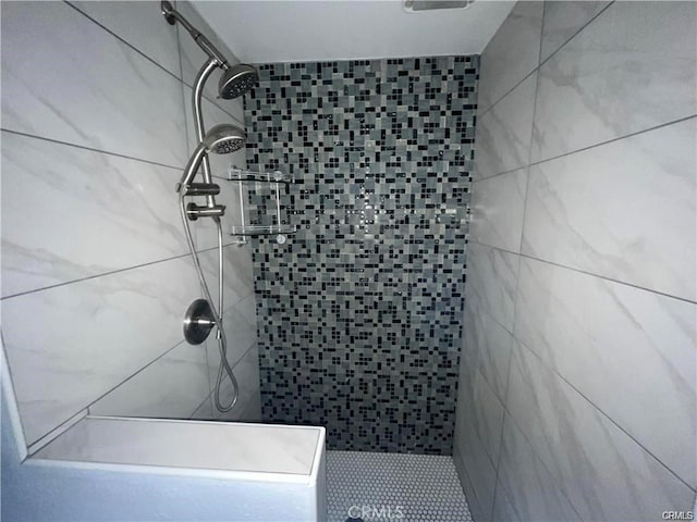 bathroom with a tile shower