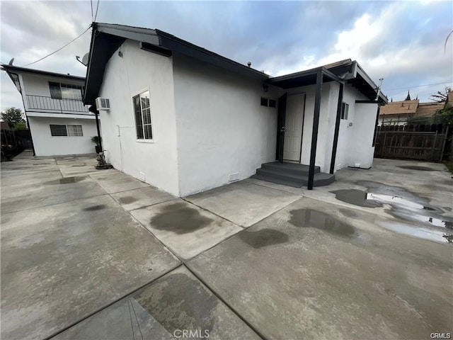 back of property with stucco siding, a patio area, and fence