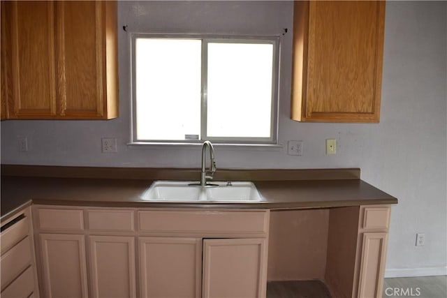 kitchen with a sink and white cabinetry