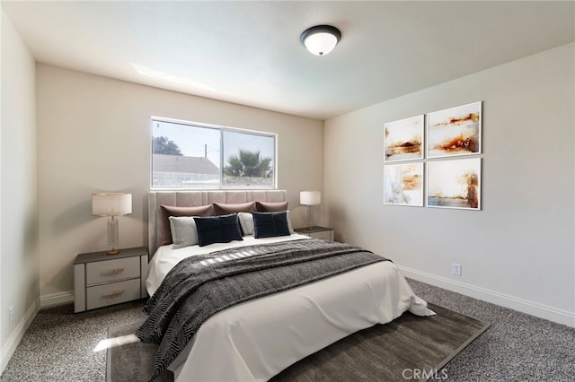 bedroom featuring baseboards and carpet