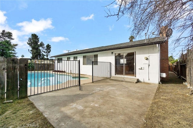 exterior space with a patio, a fenced backyard, a fenced in pool, and stucco siding