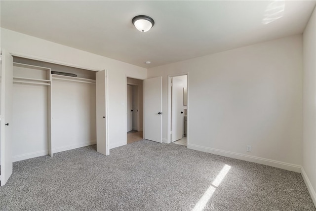 unfurnished bedroom with a closet, light carpet, and baseboards