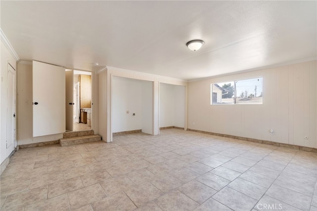 unfurnished room with crown molding