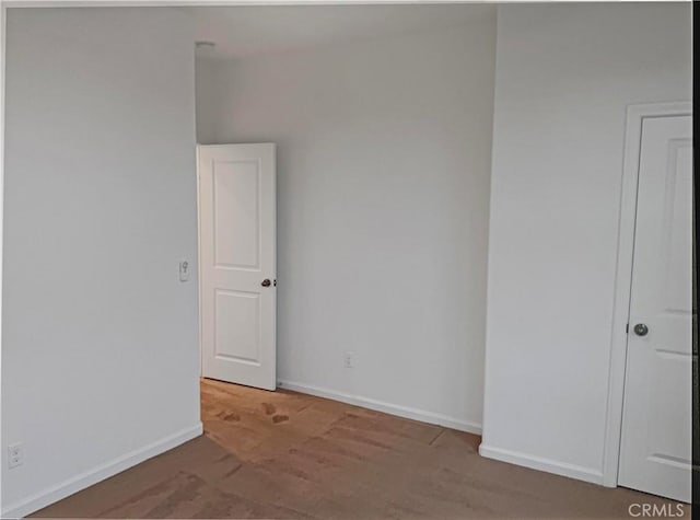 spare room featuring baseboards