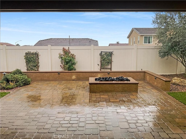 view of patio featuring a fire pit and a fenced backyard