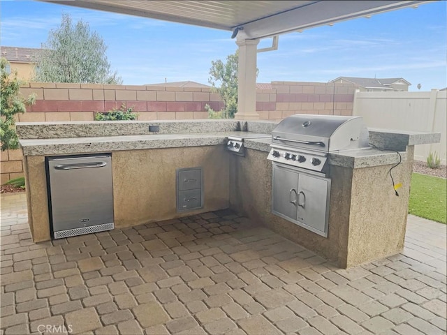 view of patio / terrace with area for grilling, a grill, and a fenced backyard