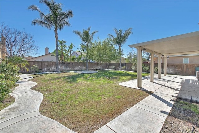 view of yard with a fenced backyard and a patio area