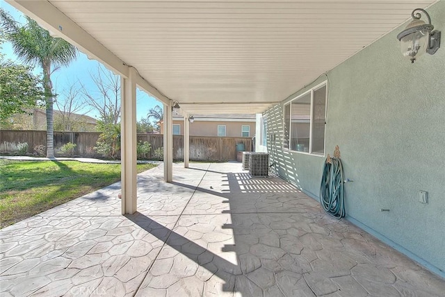 view of patio / terrace with central air condition unit and a fenced backyard