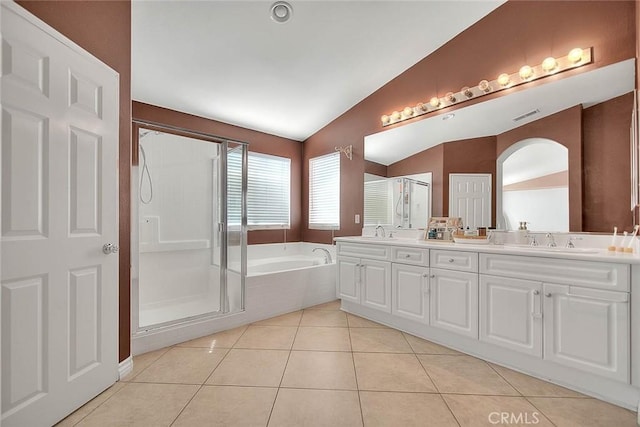 bathroom with a sink, visible vents, lofted ceiling, and tile patterned flooring