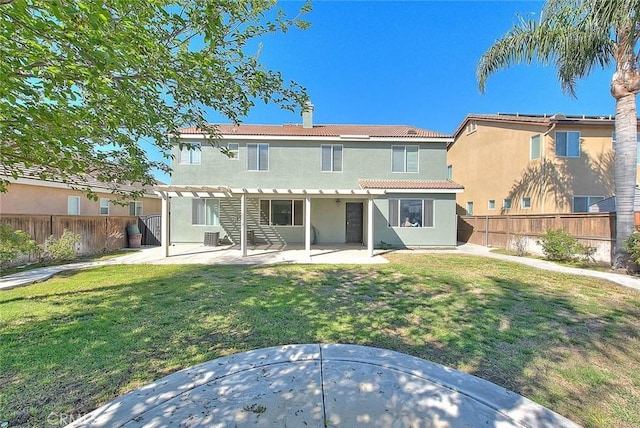 rear view of house with a patio area, a yard, a pergola, and a fenced backyard