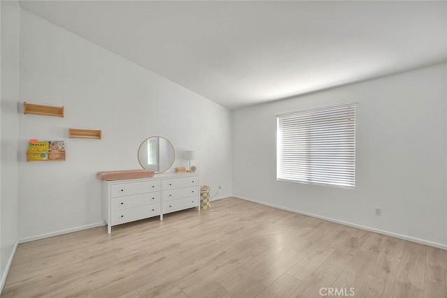 unfurnished bedroom with light wood-style flooring and baseboards