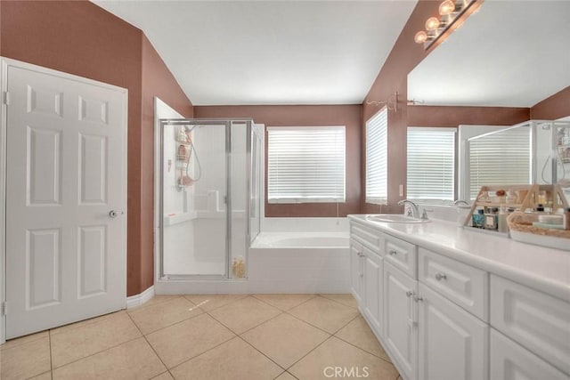 full bath with vanity, tile patterned floors, a garden tub, and a stall shower