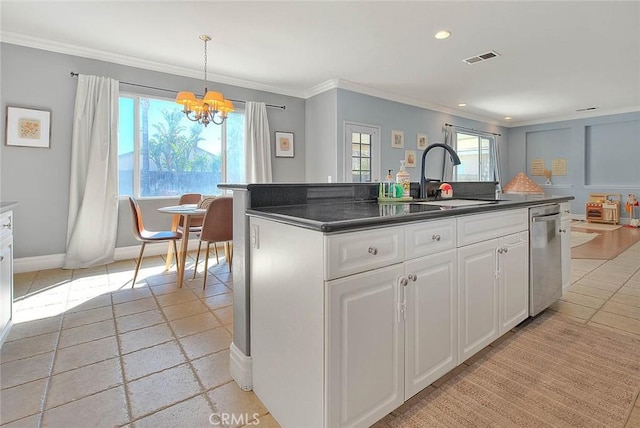 kitchen with dark countertops, visible vents, a sink, dishwasher, and a kitchen island with sink