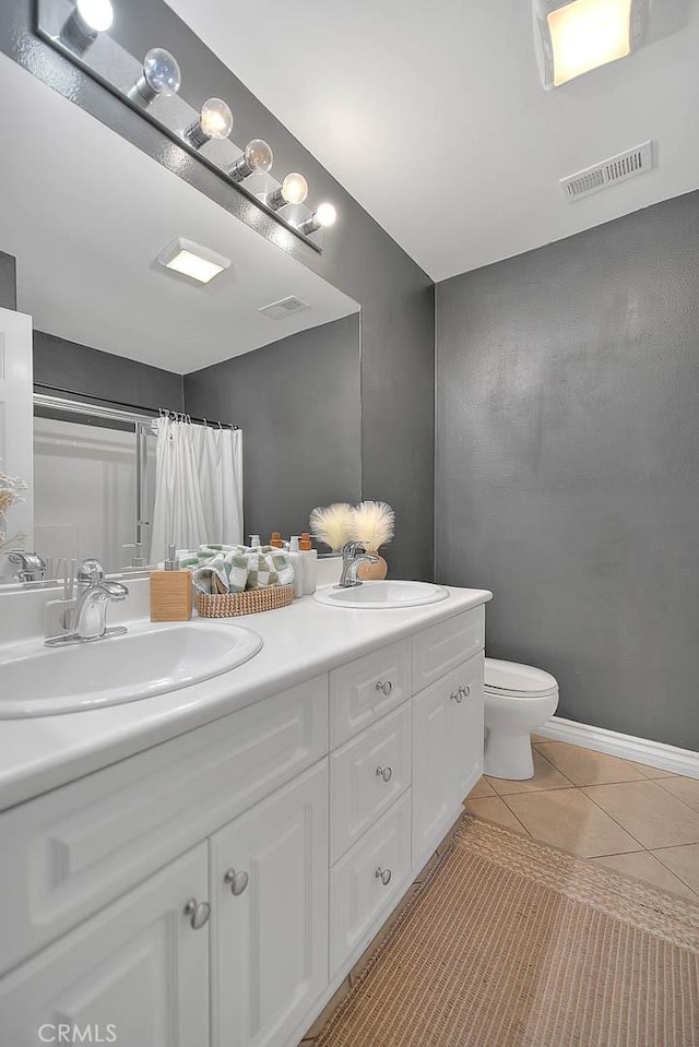 full bath featuring tile patterned flooring, visible vents, and a sink