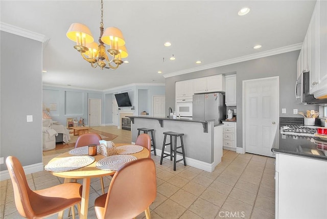 dining space featuring a chandelier, light tile patterned floors, recessed lighting, and ornamental molding