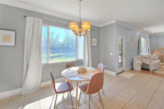 dining space with baseboards, an inviting chandelier, and ornamental molding