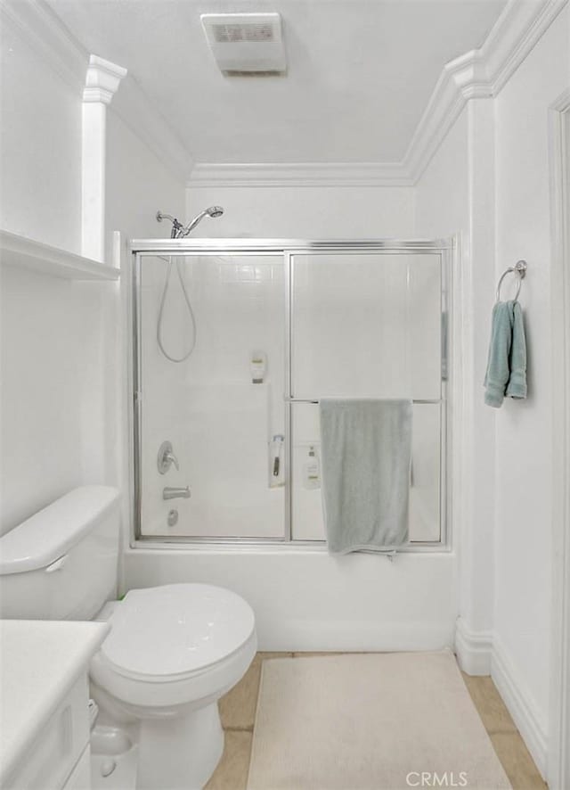 bathroom with vanity, crown molding, visible vents, and enclosed tub / shower combo