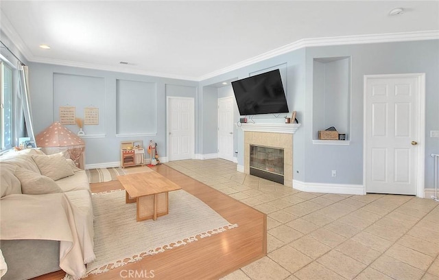 tiled living room with a tiled fireplace, visible vents, crown molding, and baseboards