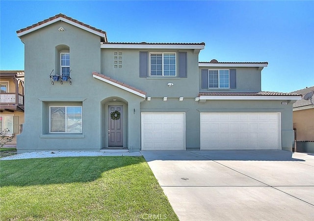 view of front of home with a tile roof, an attached garage, a front yard, and stucco siding