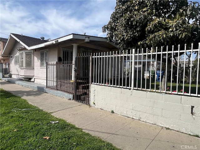 exterior space featuring concrete block siding and fence