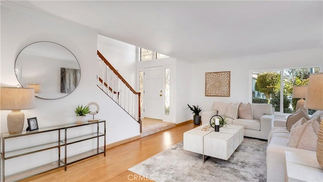 living room featuring stairway, wood finished floors, and baseboards