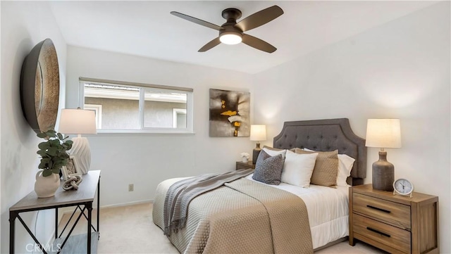 bedroom featuring light carpet, baseboards, and ceiling fan