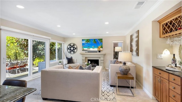 living area featuring visible vents, recessed lighting, a fireplace, crown molding, and baseboards