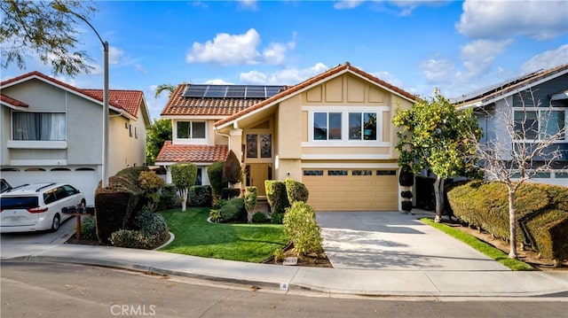 view of front of house with concrete driveway, a tile roof, roof mounted solar panels, stucco siding, and an attached garage