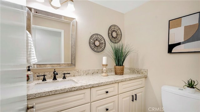 bathroom featuring vanity and toilet