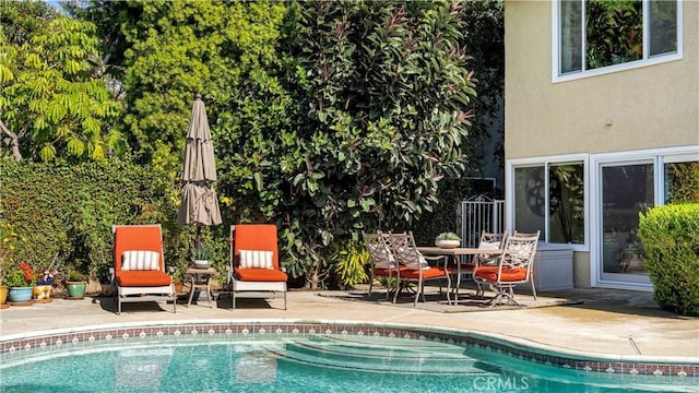 outdoor pool featuring a patio