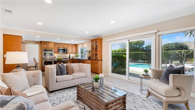 living area with crown molding, light tile patterned flooring, recessed lighting, and visible vents