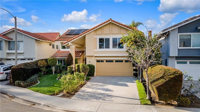 view of front of home with solar panels, stucco siding, concrete driveway, a garage, and a tile roof