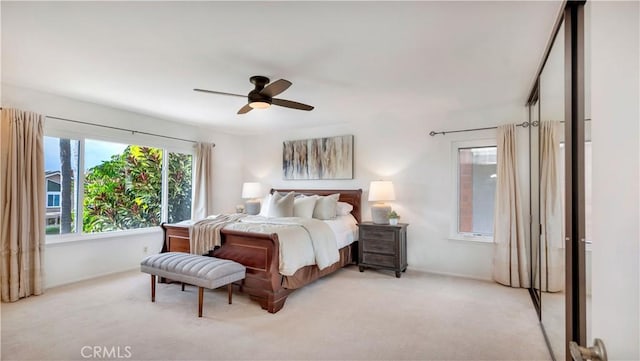 bedroom with light colored carpet and ceiling fan