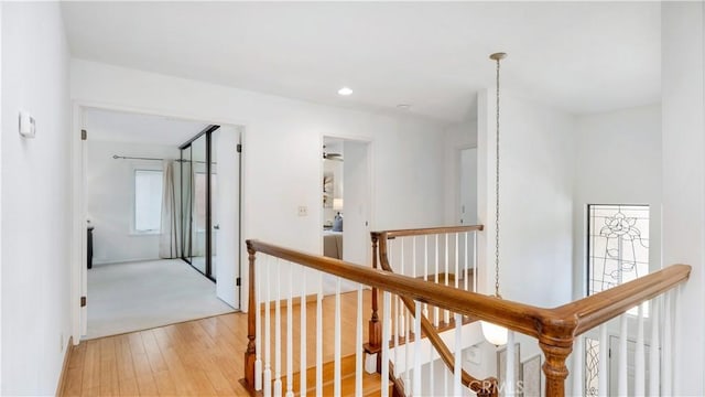 corridor with recessed lighting, an upstairs landing, and light wood finished floors