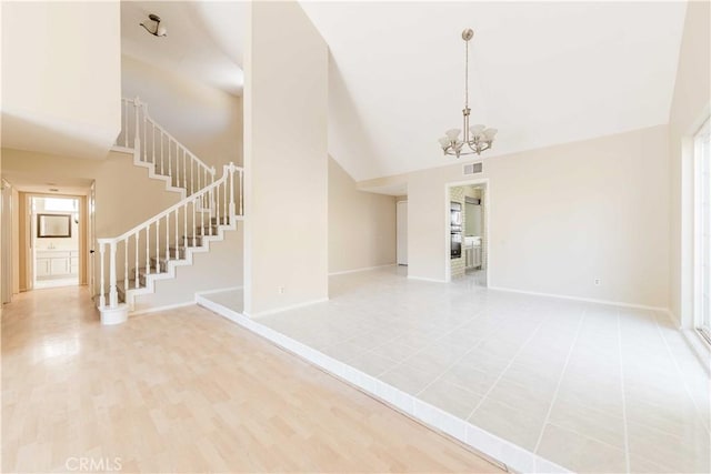 unfurnished room with stairway, baseboards, visible vents, high vaulted ceiling, and a chandelier