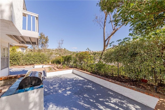 view of patio / terrace featuring fence